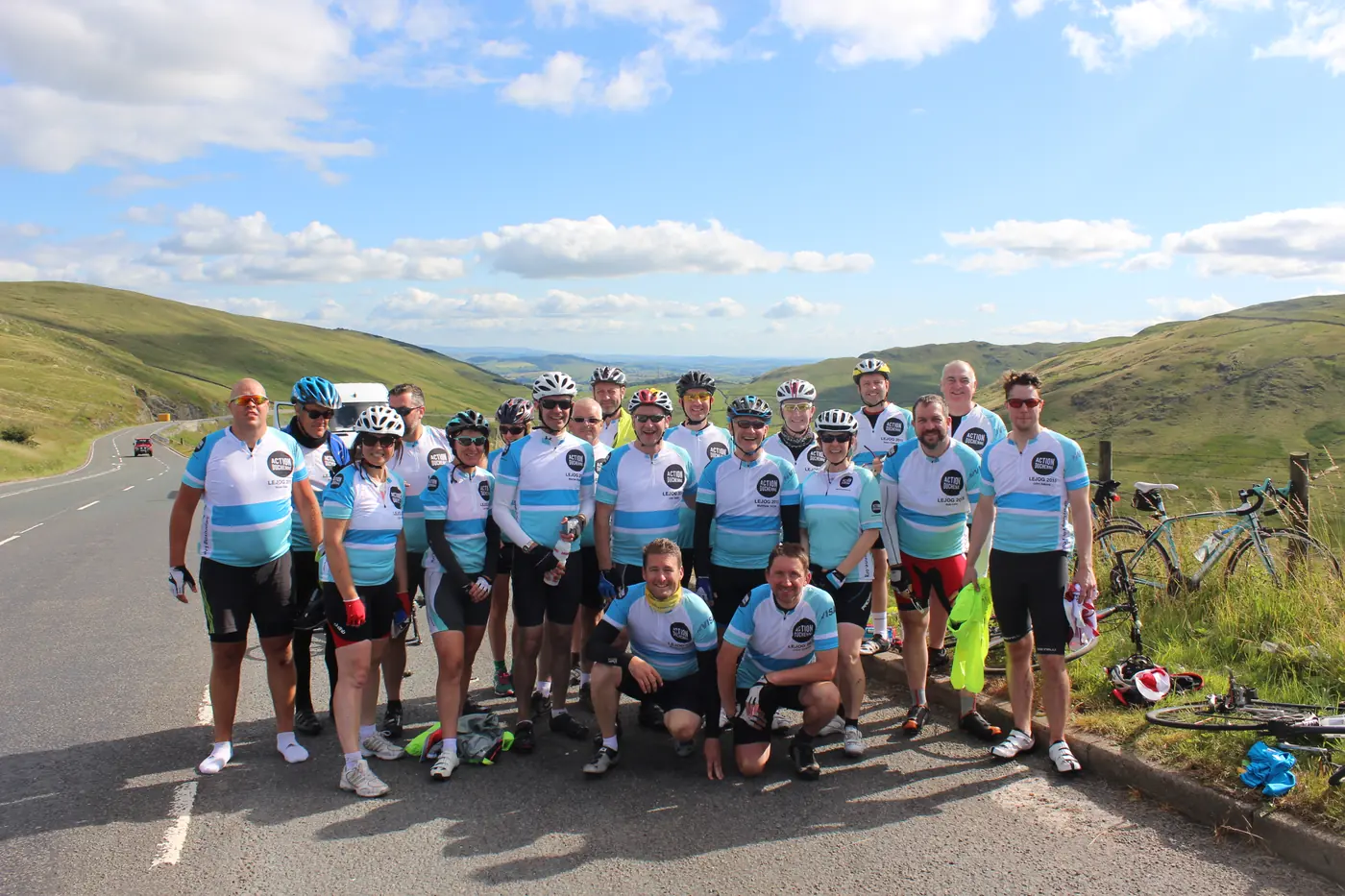 Action Duchenne charity cyclists in matching jerseys on a Scottish hillside during their Land's End to John O'Groats bike ride