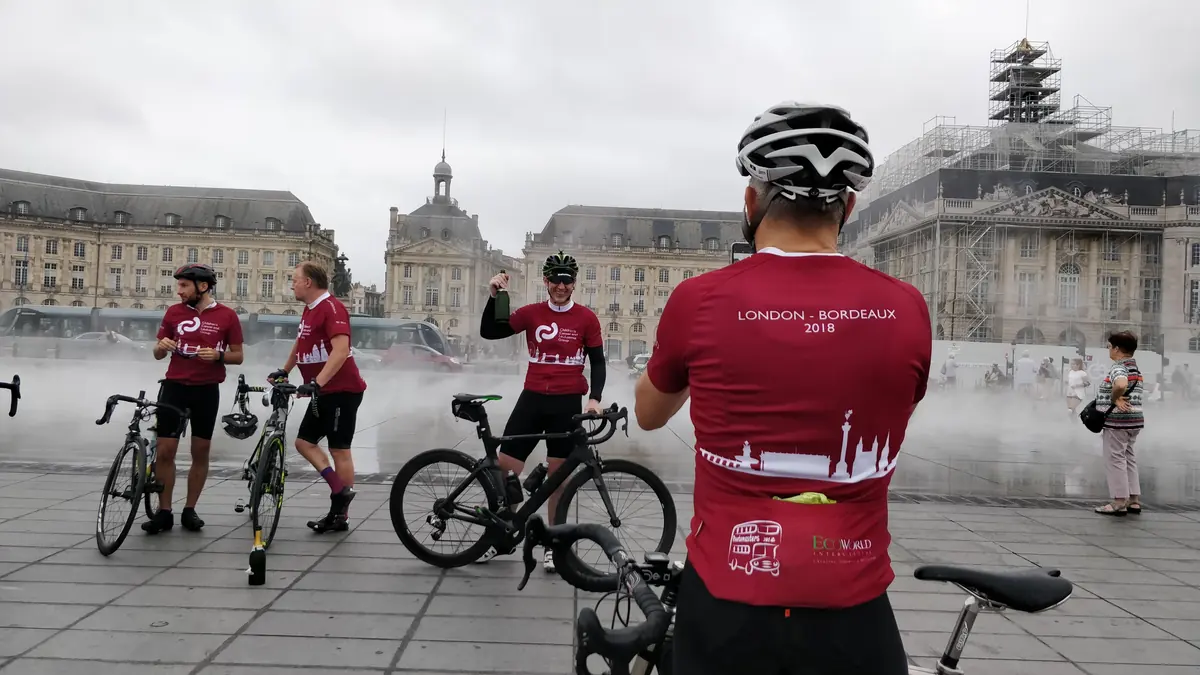 A CCLG charity cyclist arriving at the Miroir d'eau in Bordeaux at the end of a London to Bordeaux ride