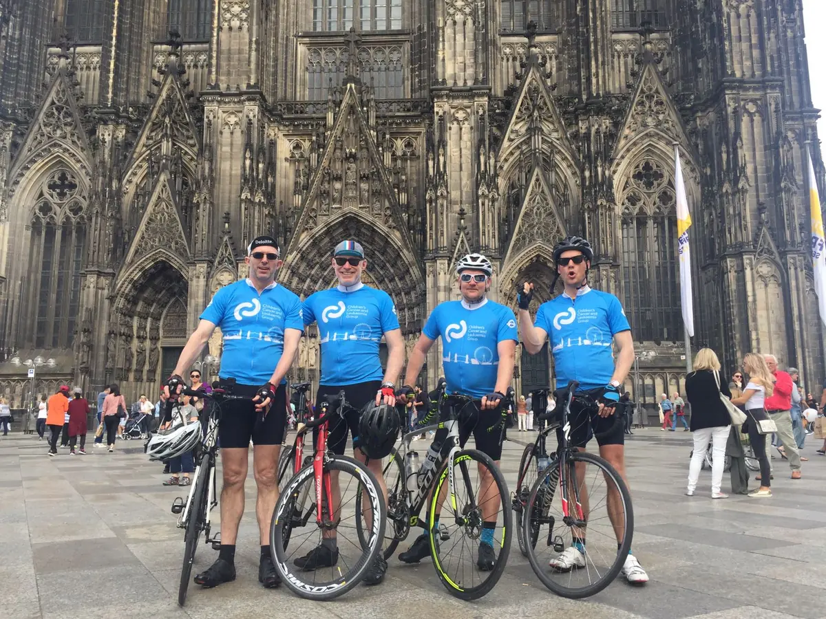 CCLG charity riders in matching jerseys in front of Cologne Cathedral