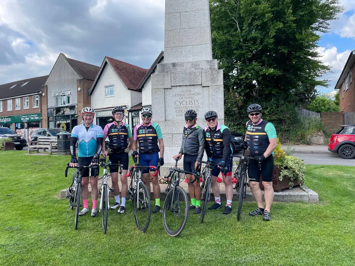 Reverse Rett charity cyclists with their bikes by a war memorial on a Warrington to London ride