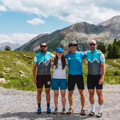Four More Adventure leaders in team kit in the mountains