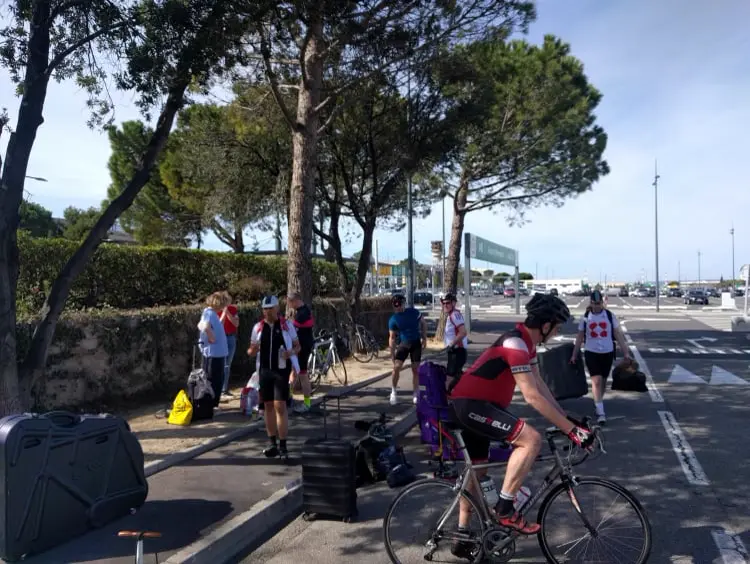 Charity riders preparing their bikes for the day's ride with the More Adventure support team