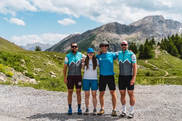 Four More Adventure cycling leaders in team kit in the mountains