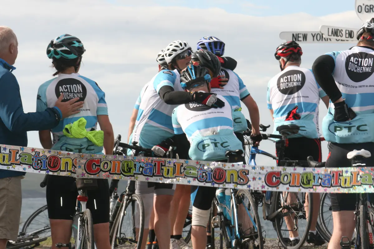 Action Duchenne riders celebrating at the John O'Groats finish