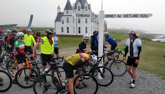 Riders at the John O&rsquo;Groats signpost
